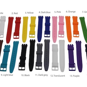 May include: A collection of fourteen silicone watch straps in various colors including white, red, yellow, dark blue, pink, orange, green, brown, light blue, black, dark grey, translucent, purple, and dark blue, each with a buckle and loop.