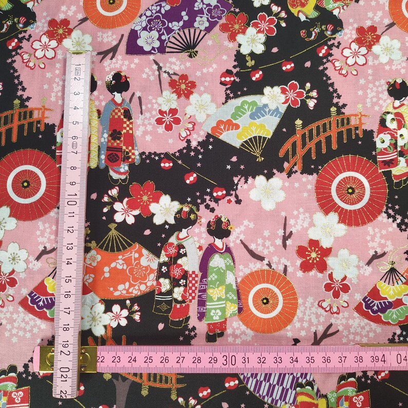 Cotton Cosmo fabric with maiko figures on a black background
