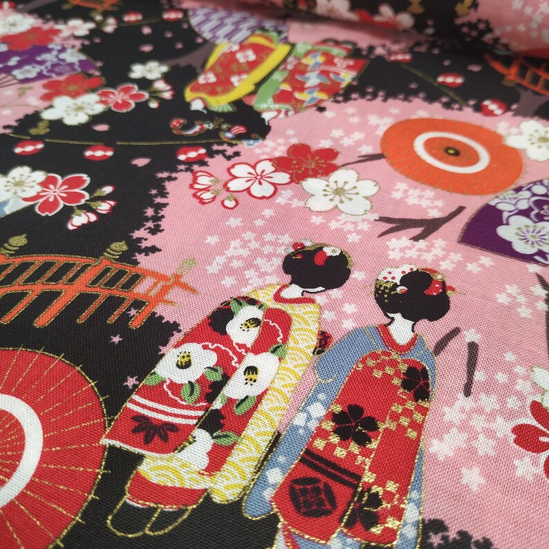 Cotton Cosmo fabric with maiko figures on a black background