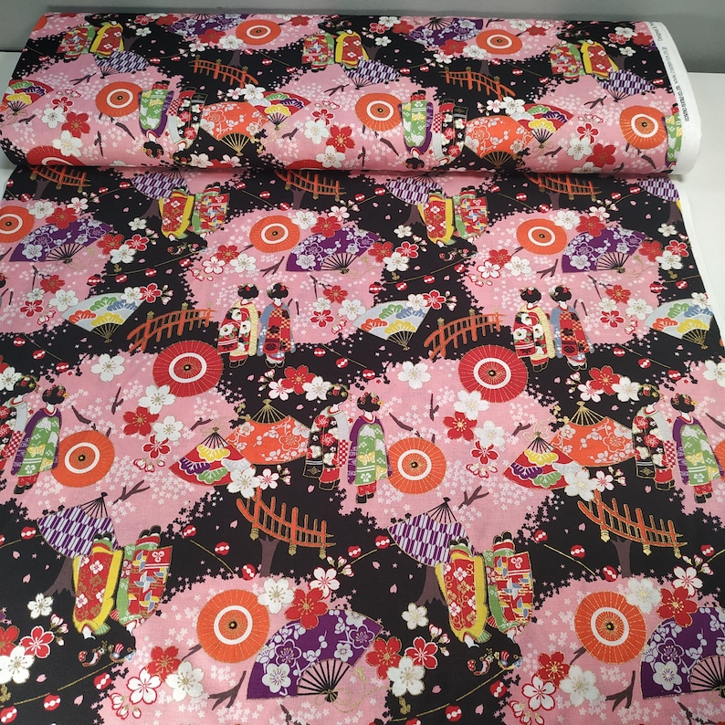 Cotton Cosmo fabric with maiko figures on a black background