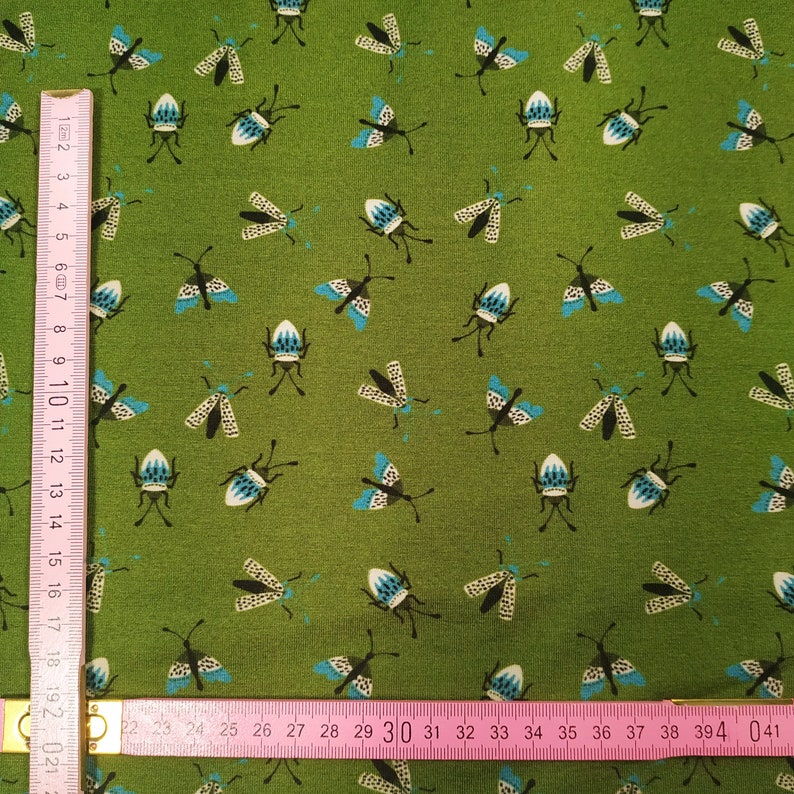 Fabbies T-shirt fabric with insects on a green background