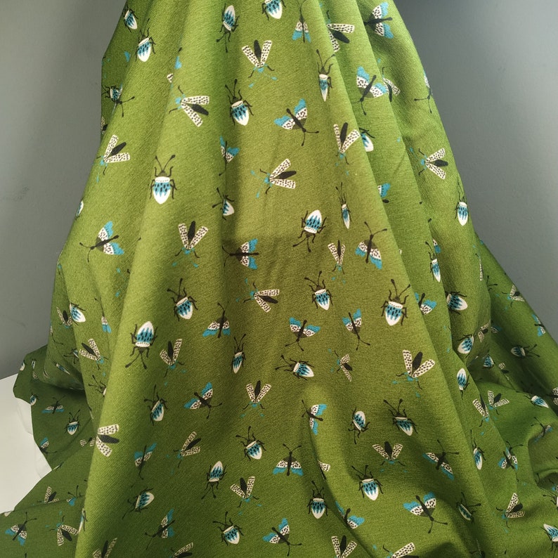 Fabbies T-shirt fabric with insects on a green background