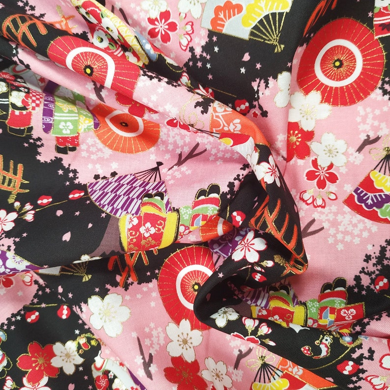 Cotton Cosmo fabric with maiko figures on a black background