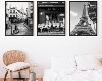 May include: Three black and white framed photographs of Paris, France. The first photo shows a cobblestone street with buildings on either side. The second photo shows a cafe with tables and chairs outside. The third photo shows the Eiffel Tower.