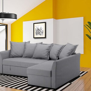 May include: A grey sectional sofa with a chaise lounge, featuring a black and white striped rug underneath. The sofa has a contemporary design and is positioned in a room with yellow and white walls.
