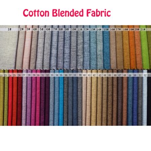 May include: A swatch card of 53 different cotton blended fabrics. The swatches are arranged in rows and numbered from 1 to 53. The fabric colors range from light beige to dark green.