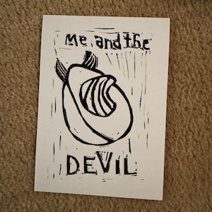 May include: Black and white linocut print of an avocado with the text "Me and the Devil" printed below.