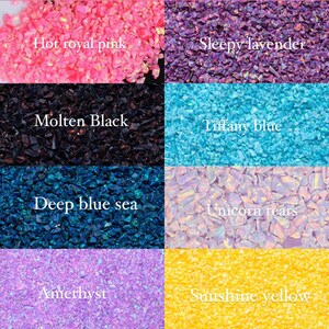 May include: A collection of crushed opal in various colors, including hot royal pink, sleepy lavender, molten black, Tiffany blue, deep blue sea, unicorn tears, amethyst, and sunshine yellow. Each color is labeled with white text.