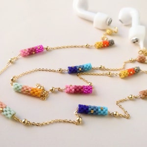 May include: A gold chain with colorful beaded charms, designed to hold wireless earbuds. The charms are made of small, colorful beads arranged in a gradient pattern.