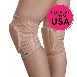 May include: Beige knee pads with a mesh design and padded support. The pads are designed to protect the knees. The word "QUEEN" is printed on the side of one of the pads.