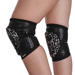 May include: Pair of black and white knee pads with a leopard print design. The knee pads have a mesh fabric and a padded area for protection. The text "OLCEN" is printed on the knee pad.