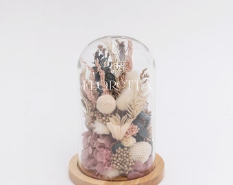 Magic rose under a glass cover on a wooden stand, Cream colored dried flowers and preserved flowers in vintage decor