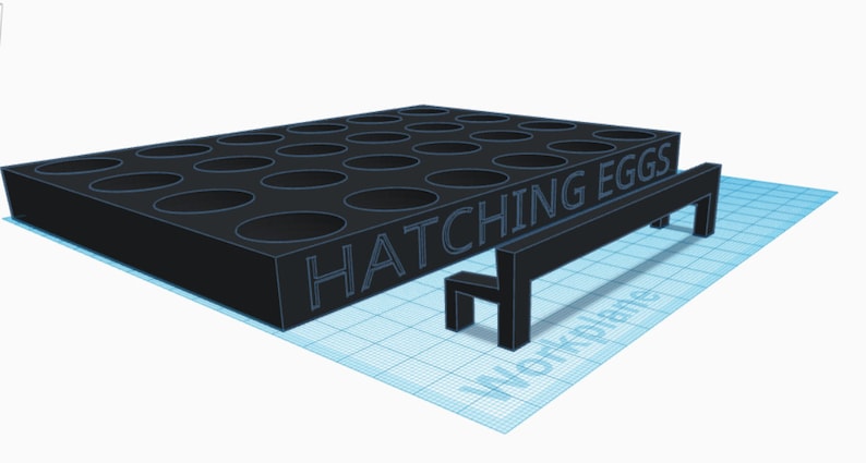 May include: A black plastic egg incubator with 25 circular holes and the text "HATCHING EGGS" on the front. A small black bench is in front of the incubator.