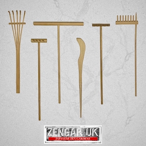 May include: A set of six wooden garden tools for raking and smoothing sand in a Zen garden. The tools include a rake, a rake with a long handle, a rake with a short handle, a flat rake, a long-handled rake, and a tool for smoothing sand.