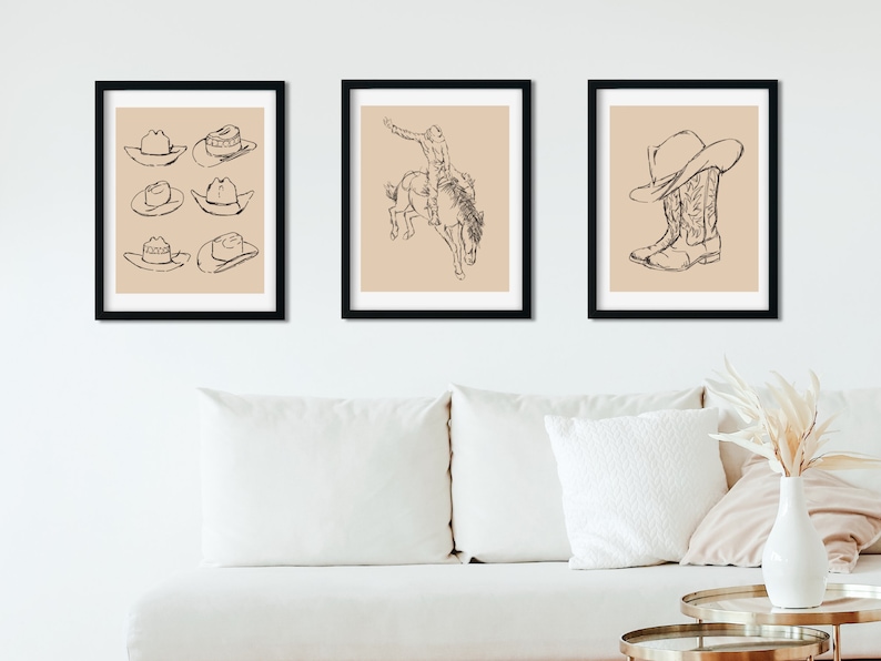 May include: Three framed illustrations in black frames with a beige background. The left frame shows six different cowboy hats. The middle frame shows a cowboy riding a bucking horse. The right frame shows a cowboy boot with a cowboy hat on top.