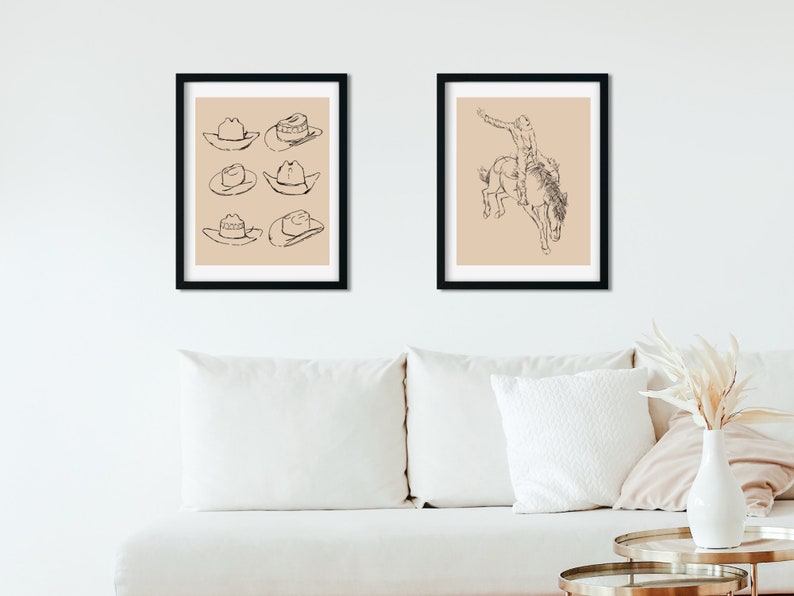 May include: Two framed black and white line drawings. The first drawing shows six cowboy hats. The second drawing shows a cowboy riding a bucking horse.