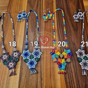May include: Four sets of beaded necklaces and matching earrings labeled 18, 19, 20, and 21. Each set features intricate floral patterns made of small colorful beads. The designs include geometric shapes, hanging fringe details, and long beaded chains.