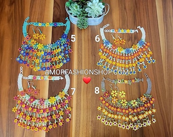 May include: Four beaded necklace sets with matching earrings and bracelets. Each set features a floral design with colourful beads. The sets are in blue, orange, pink, and yellow. The website address AMORFASHIONSHOP.COM is visible.