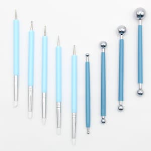 May include: Set of nine blue and silver cake decorating tools with various ball and pointed tips.