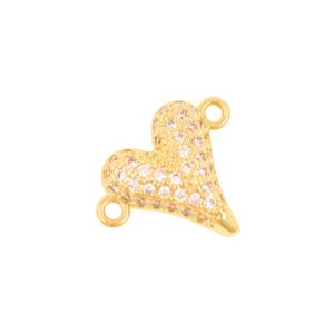 May include: A gold-toned heart-shaped jewelry connector featuring a textured surface embedded with numerous small, clear, sparkling stones. The piece includes two small circular loops, one at the top and one at the bottom, for attachment.