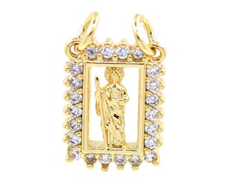 May include: Gold pendant with a clear crystal frame and a small image of a saint inside.