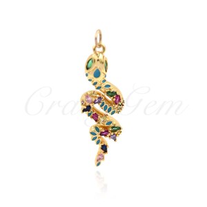 May include: Gold snake pendant featuring colourful gemstones. The snake is curled up and has a turquoise enamel body. The pendant is ideal for adding a touch of whimsy to any outfit.
