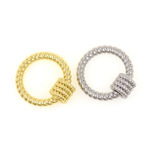 May include: Two metal jewelry clasps. One is gold-toned, the other is silver-toned. Both clasps have a circular design with a twisted rope texture and a square knot detail. The clasps are set against a white background.