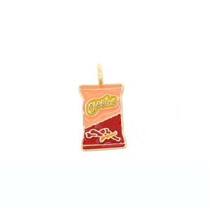 May include: A gold-toned pendant in the shape of a Cheetos snack bag. The bag is primarily orange and red with the word "Cheetos" in yellow. The pendant has a loop at the top for a chain.