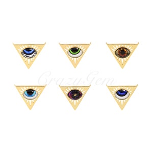May include: Six gold triangle pendants featuring various eye designs. The eyes are colourful and display a range of patterns. These pendants are ideal for adding a distinctive touch to any jewellery project.
