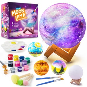 May include: A moon lamp painting kit featuring a box with the text Paint your MOON LAMP PAINTING KIT, a large spherical lamp with a purple and blue galaxy design on a wooden stand, several painted spheres, paint pots, brushes, and sponges.