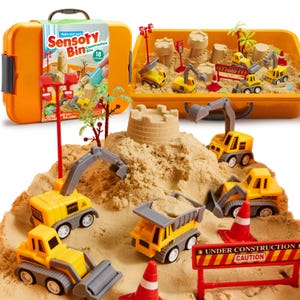 May include: A construction site sensory bin kit featuring an orange plastic storage case, tan kinetic sand, and yellow toy construction vehicles including excavators, dump trucks, and a roller. Includes red traffic cones and caution signs.