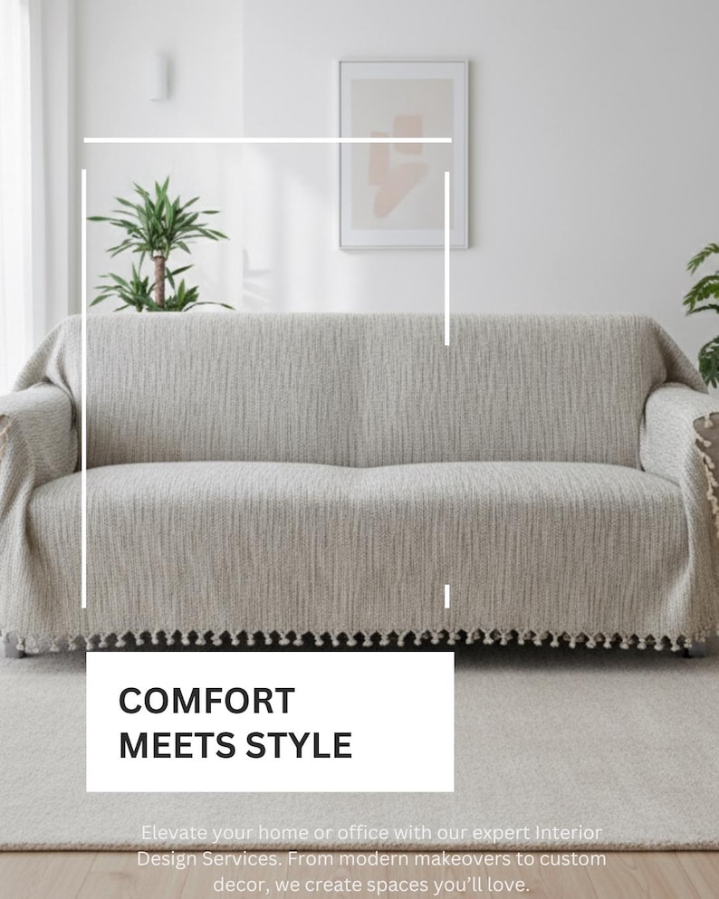 May include: A beige sofa cover with a textured, woven fabric finish and a decorative fringe along the bottom edge. The cover is draped over a sofa, featuring the text COMFORT MEETS STYLE in a white box, with additional text below the box.