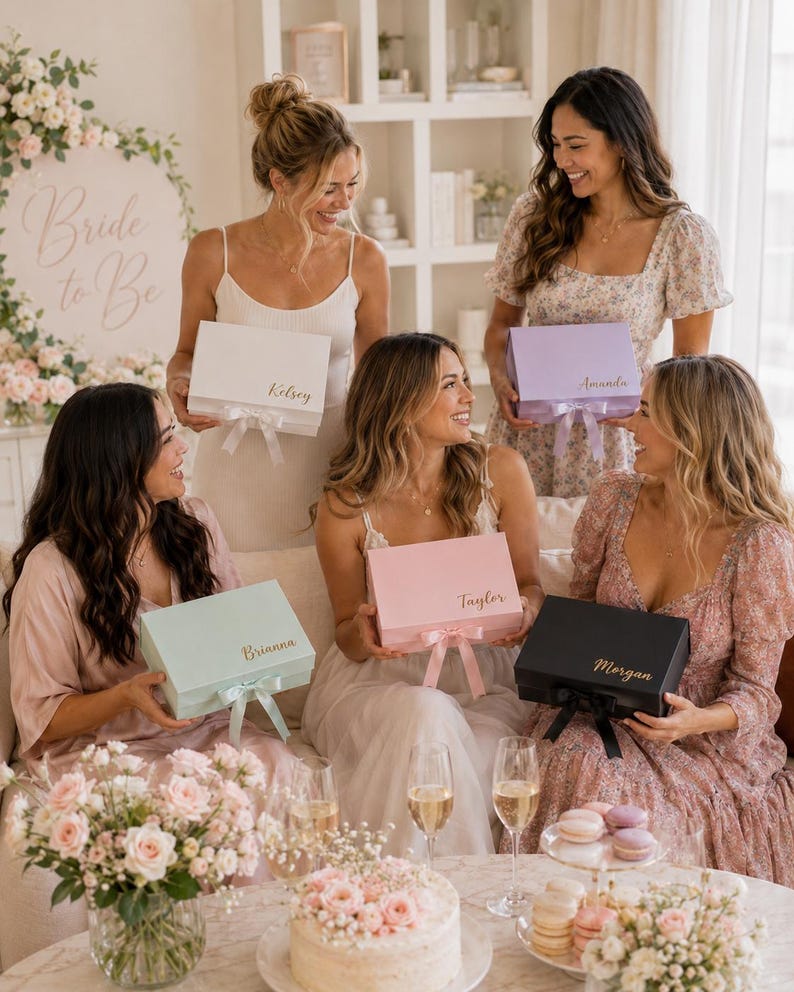 May include: A group of women holding gift boxes in various pastel colors, each with a name on top. The boxes have matching ribbons. A sign that says "Bride to Be" is in the background. Champagne glasses and a cake are on the table.