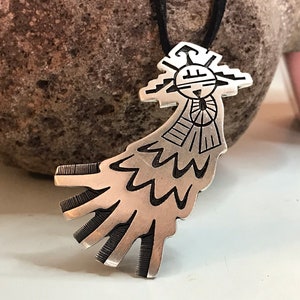 This vintage HOPI STERLiNg OVERLAY KaCHiNa PENDANT is BEAUTIFULLY MADE!  Nice deep cuts and a stylized modern design make this a very unique pendant.  It's unsigned but  the unusual tiny feathery design on the bottom that looks like tiny combs, can be seen in the work of Sparks Masawytewa.  It's in great condition and has a generous bale on the back.   It's 2-1/8"  and would make a lovely gift for someone who loves Native American Jewelry.