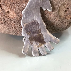 This vintage HOPI STERLiNg OVERLAY KaCHiNa PENDANT is BEAUTIFULLY MADE!  Nice deep cuts and a stylized modern design make this a very unique pendant.  It's unsigned but  the unusual tiny feathery design on the bottom that looks like tiny combs, can be seen in the work of Sparks Masawytewa.  It's in great condition and has a generous bale on the back.   It's 2-1/8"  and would make a lovely gift for someone who loves Native American Jewelry.