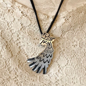 This vintage HOPI STERLiNg OVERLAY KaCHiNa PENDANT is BEAUTIFULLY MADE!  Nice deep cuts and a stylized modern design make this a very unique pendant.  It's unsigned but  the unusual tiny feathery design on the bottom that looks like tiny combs, can be seen in the work of Sparks Masawytewa.  It's in great condition and has a generous bale on the back.   It's 2-1/8"  and would make a lovely gift for someone who loves Native American Jewelry.