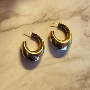 These vintage HALF HOOP EARRiNGS are FABULOUS!  They're gold vermeil over sterling.  The shape is a half hoop or crescent.  They're carinated and puffy or 3-d.  They're lightweight and wear beautifully.  I've left the original patina or tarnish.