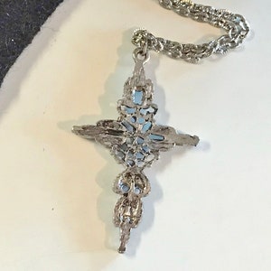 This vintage ZUNI styLe Petit PoiNT CroSS NECKLACE is a great pretender!  Turquoise plastic cabochons mimic the petit point jewelry the Zuni Indians are famous for.  They're set in a silver tone metal.  It's a pretty little western cross that comes on a really nice silver rolo chain.  The links have a  nice stamped line pattern.  You'll receive the pendant and 24" chain.