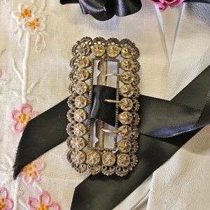 This vintage ViCTORIAN StERLiNG SASH BUCKLE is an amazing!  It's a whopping 3-1/4" long and has Delicate lacy filigree edges and faceted circles of silver that twinkle and shine.  There are 3 sharp prongs that swivel back and forth on a hinge.  There is also a second piece of metal on the back with 4 prongs that also swivels...perhaps to hold the material secure.  It's in great condition and would look glorious on a wedding belt.  Original Patina or very tarnished.