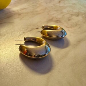 These vintage HALF HOOP EARRiNGS are FABULOUS!  They're gold vermeil over sterling.  The shape is a half hoop or crescent.  They're carinated and puffy or 3-d.  They're lightweight and wear beautifully.  I've left the original patina or tarnish.