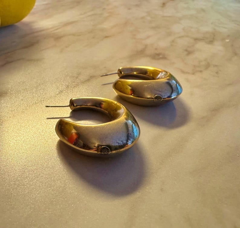 These vintage HALF HOOP EARRiNGS are FABULOUS!  They're gold vermeil over sterling.  The shape is a half hoop or crescent.  They're carinated and puffy or 3-d.  They're lightweight and wear beautifully.  I've left the original patina or tarnish.