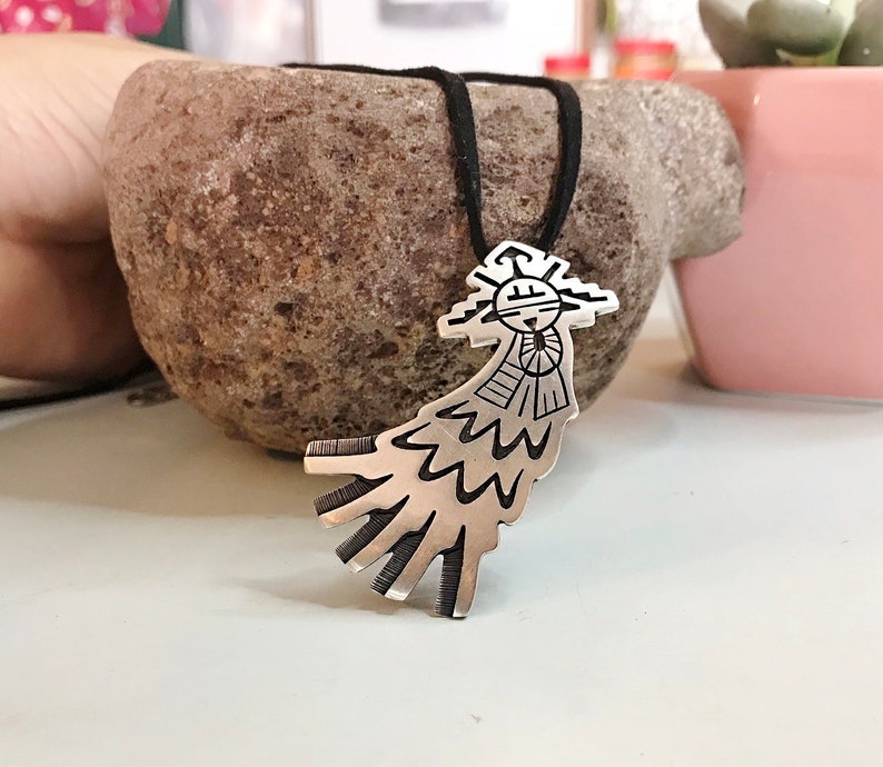 This vintage HOPI STERLiNg OVERLAY KaCHiNa PENDANT is BEAUTIFULLY MADE!  Nice deep cuts and a stylized modern design make this a very unique pendant.  It's unsigned but  the unusual tiny feathery design on the bottom that looks like tiny combs, can be seen in the work of Sparks Masawytewa.  It's in great condition and has a generous bale on the back.   It's 2-1/8"  and would make a lovely gift for someone who loves Native American Jewelry.