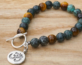 Pulsera de turquesa africana y ojo de tigre con encanto Om / pulsera de piedras preciosas / pulsera de dijes