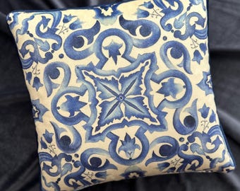 May include: A decorative throw pillow with a blue and white geometric pattern. The pattern features intricate swirls and floral motifs.