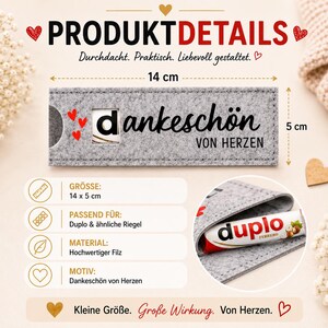 May include: A rectangular grey felt sleeve measuring 14 cm by 5 cm, featuring the black text "dankesch&ouml;n VON HERZEN" and three small red hearts. A circular cutout reveals a portion of a Duplo chocolate bar inside the sleeve.