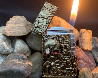 Skull flint lighter gold refillable flip top, engraved metal.