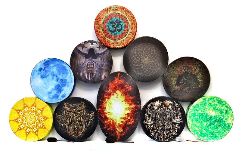 May include: Nine round hand drums with different designs, including a blue moon, a fire, a lion, an owl, a mandala, a Buddha, a green galaxy, a woman with a bird, and a geometric pattern. The drums are arranged in a pyramid shape.