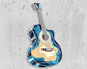 May include: A blue and beige acoustic guitar with a layered, paper-like design. The guitar has a light wood body and a dark wood neck.