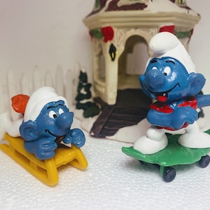 SUPERSMURF-0202_Set of 2 Pre-owned Vintage Peyo Schleich Super Smurfs figures 40201 Bobsled 40204 Skateboard Smurf Toy Schtroumpf figurine