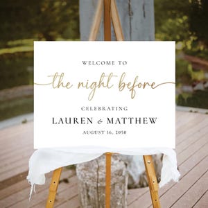 May include: White sign with black text that reads "Welcome to the night before celebrating Lauren & Matthew August 16, 2050". The sign is on a wooden easel.